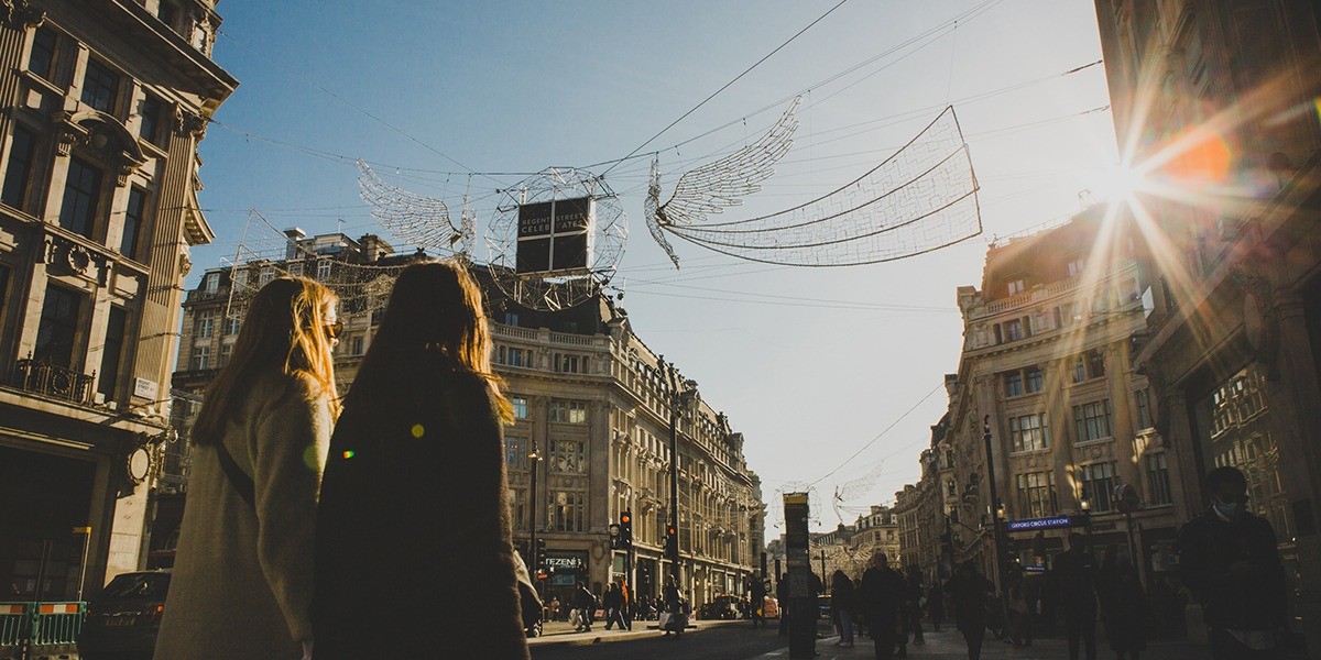 Two women walking down Regent Street in the winter sunshine