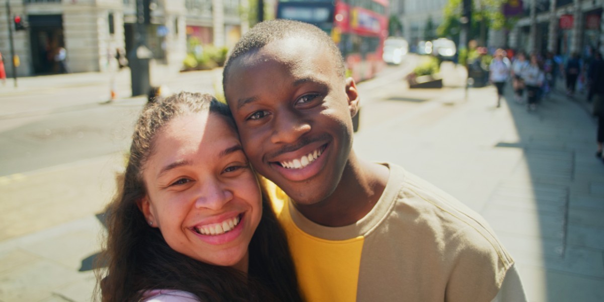 Two friends posing for a selfie on a street