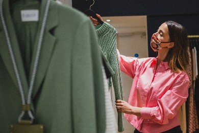 Woman looking at a shirt in a shop on Regent Street