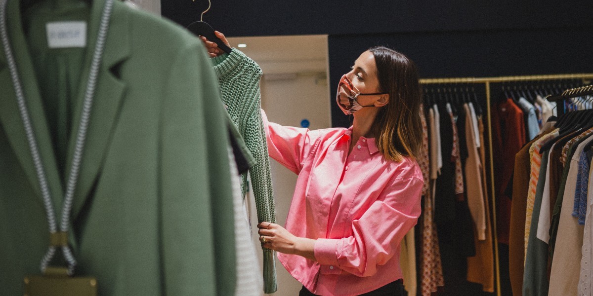 Woman looking at a shirt in a shop on Regent Street